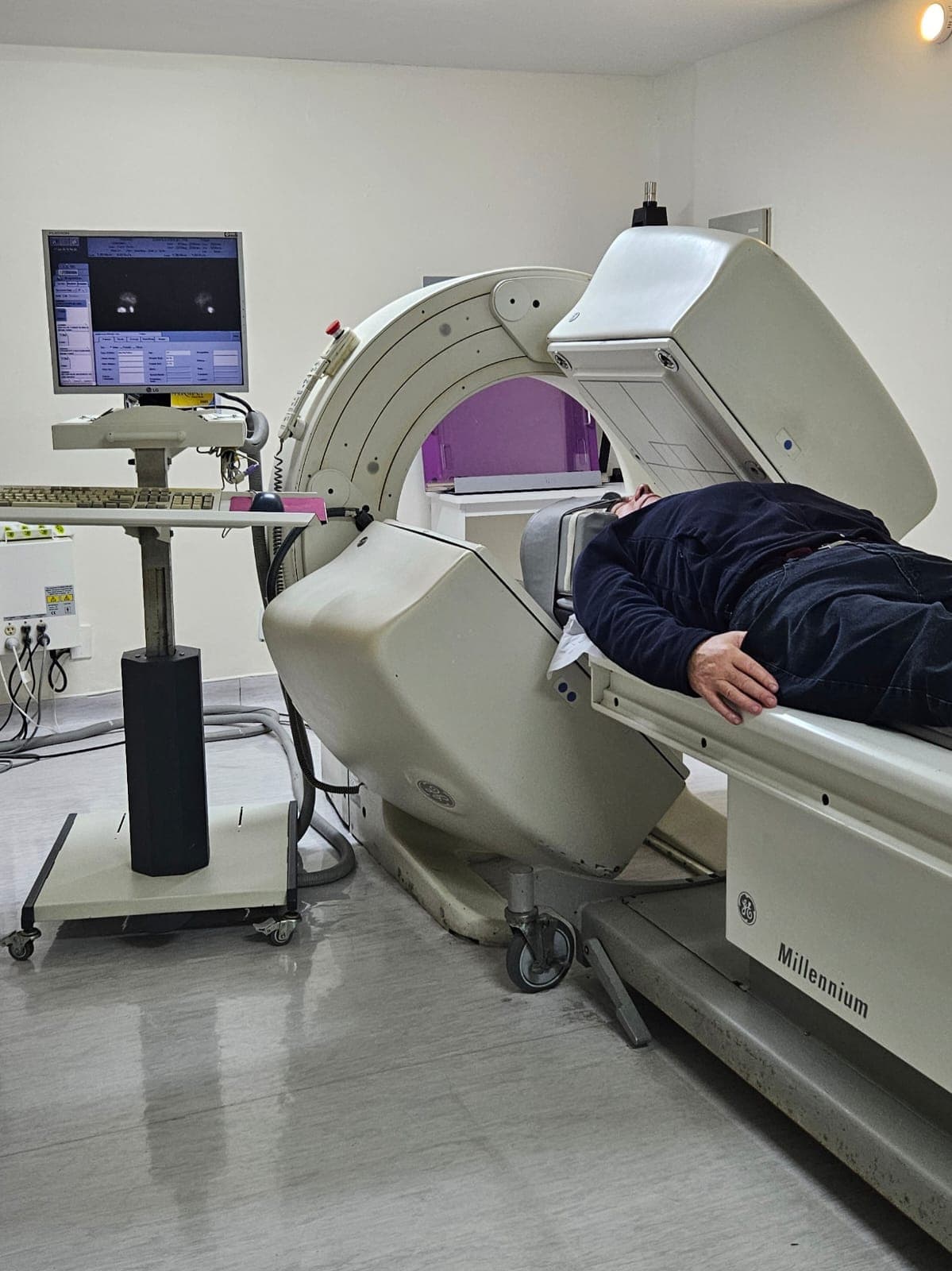 Paciente durante cintilografia em gama-câmara GE — o exame é tranquilo, indolor e feito com a sua própria roupa.